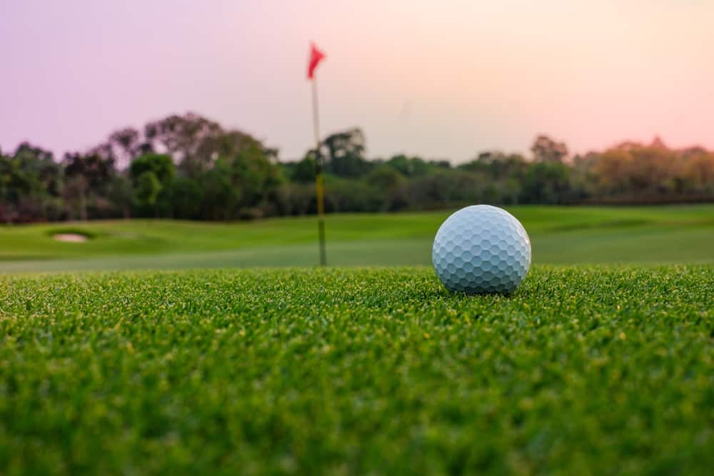 ball on a golf course at sunset
