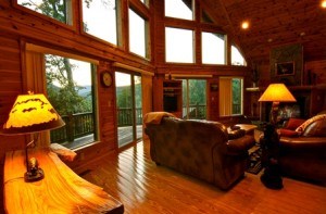 log cabin living room with floor to ceiling windows and couch