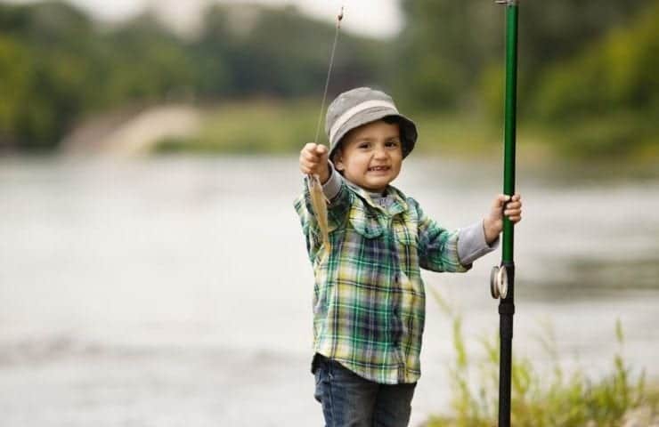 Little boy with fishing pole and fish