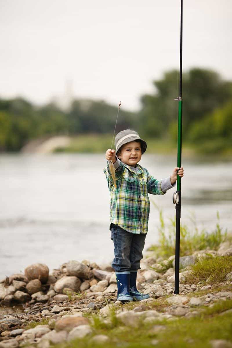 Little boy with fishing pole and fish