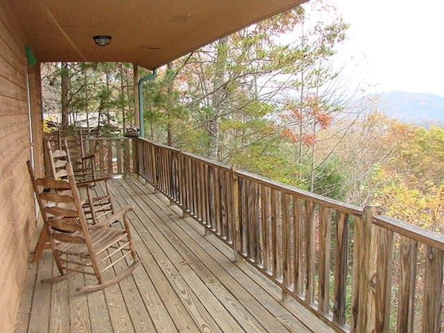 Wooden rocking chairs on the deck of a cabin in Murphy NC with great views.