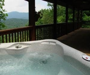 Hot tub on the porch of a Murphy NC cabin with mountain views