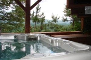 hot tub on deck of one of best cabins in north carolina