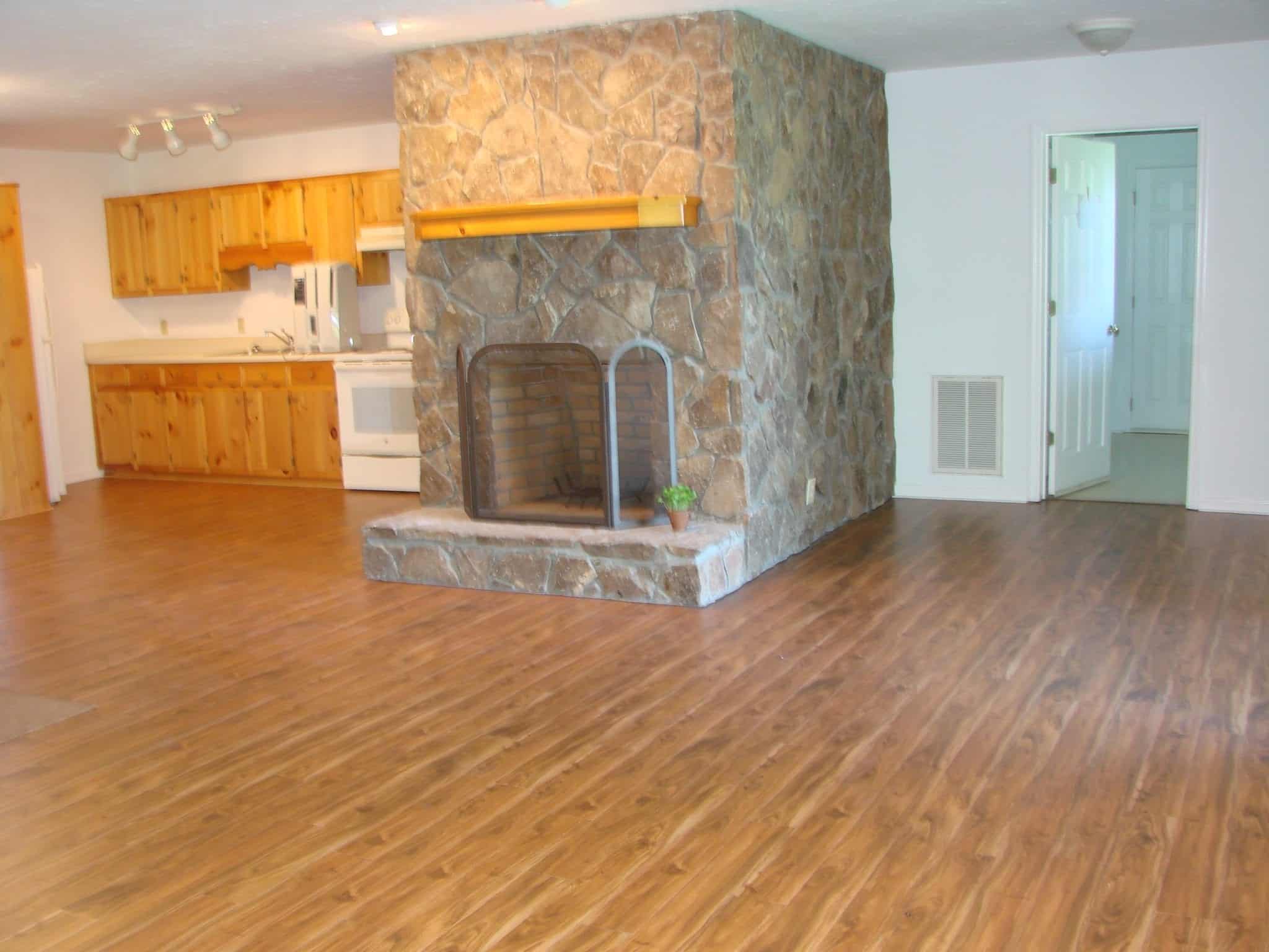 A vacation rental in Murphy NC with wood floors and a stone fireplace.
