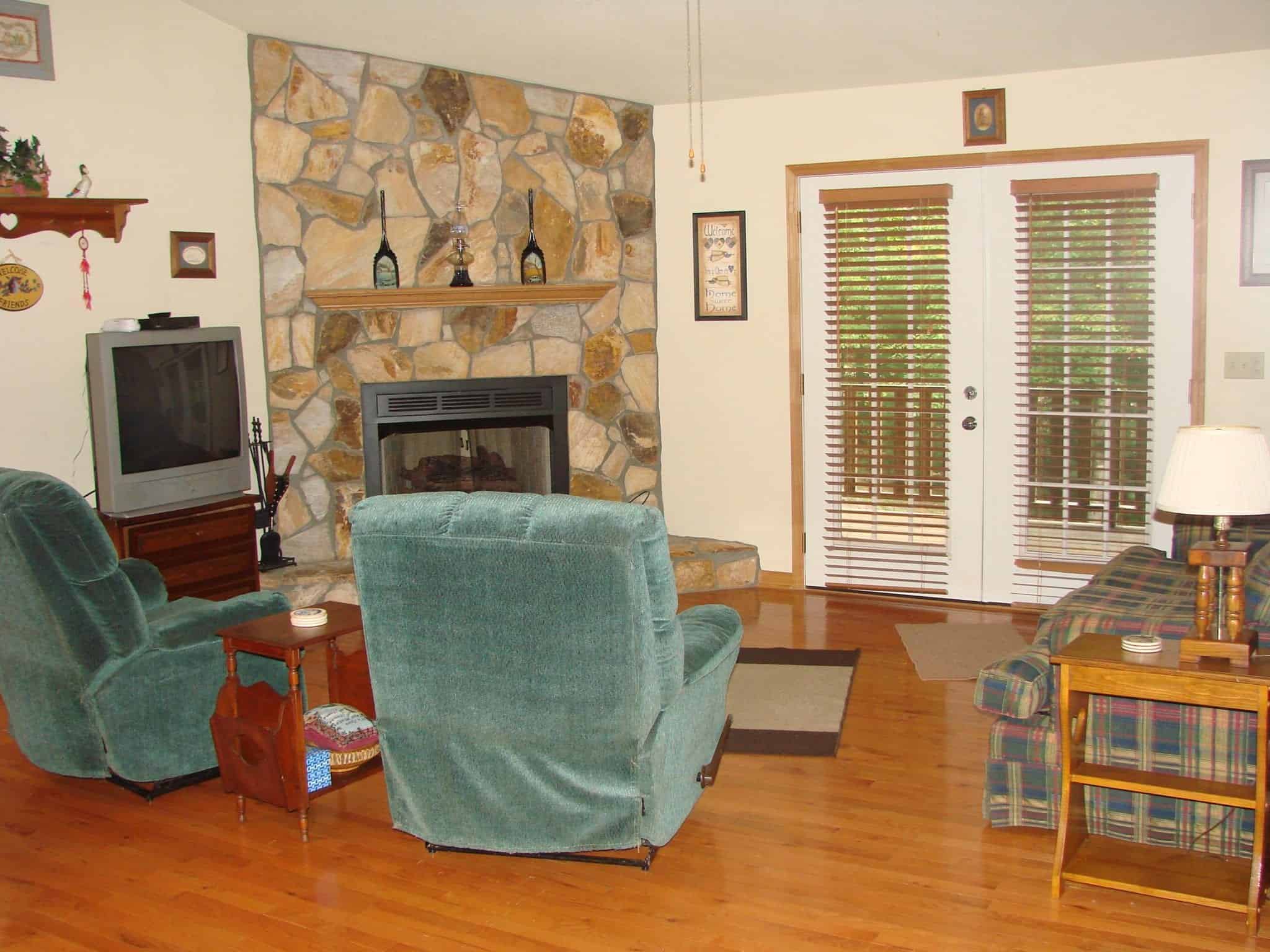 A stone fireplace and furniture in a Murphy NC cabin rental.