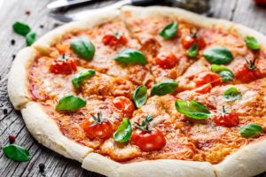 A pizza with fresh tomatoes and basil.