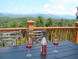 wine glasses on a patio table with a mountain view