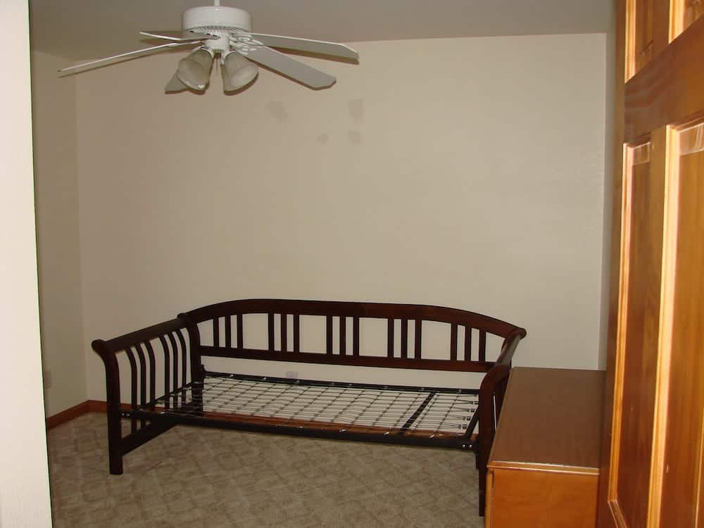 empty room with a bed frame