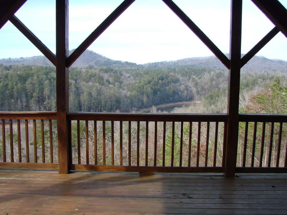 front porch on a cabin with a view of hills