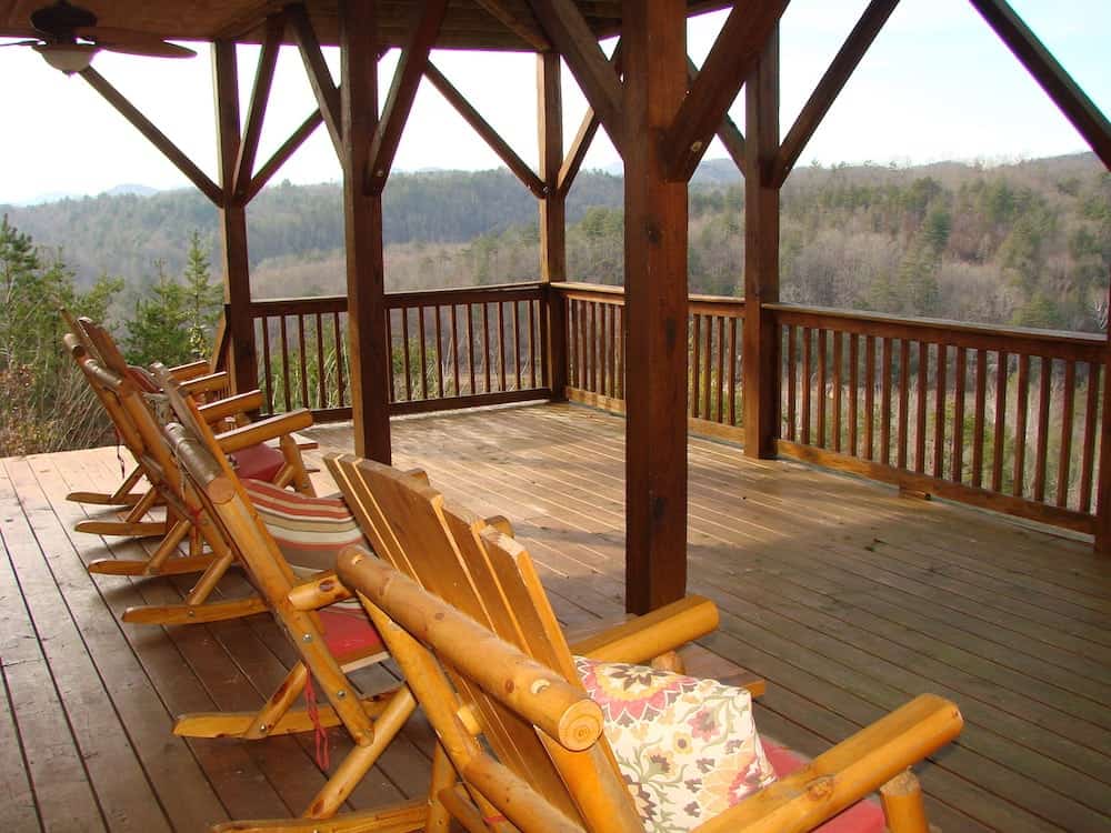 rocking chairs on a porch with mountain views
