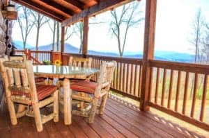 deck on a cabin with table and chairs